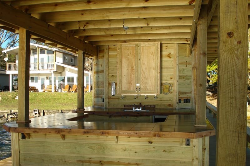 Covered boathouse deck with a built-in wood counter and cabinets