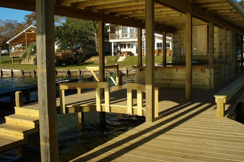 Covered boathouse deck with steps down toward the water