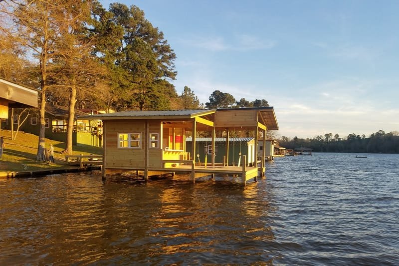 Wood boathouse over the lake in evening light