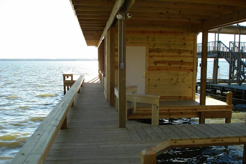 Pier with a built-in bench leading along an enclosed boathouse