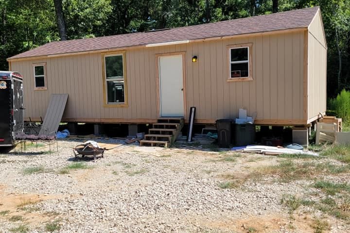 Small cabin with board-and-batten siding, set on piers