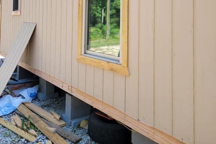 Board-and-batten siding and window trim on a small cabin