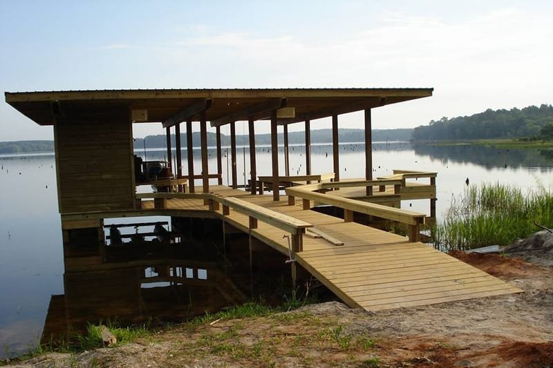 Covered pier with built-in benches and a walkway from the shore