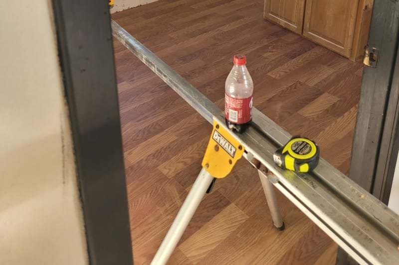 Wood-look flooring installation in progress, with tools on the floor
