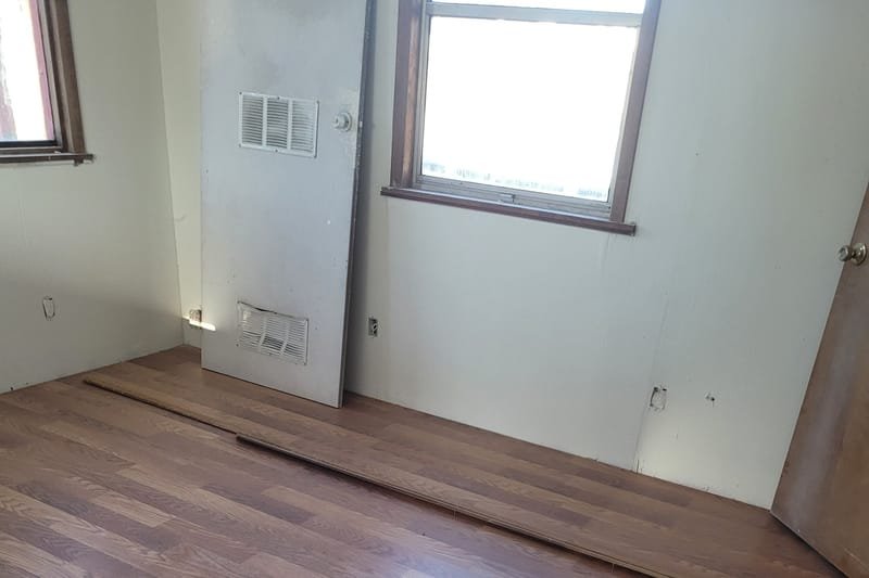 Newly installed wood-look flooring in an empty bedroom