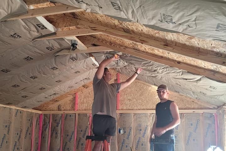 Insulation going into the walls and ceiling of a room