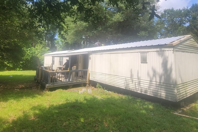 Mobile home with a new white metal roof