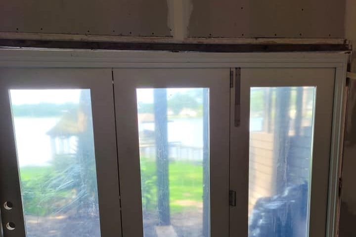 New glass patio doors installed in a room under renovation