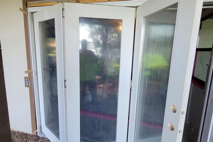 New white multi-panel patio doors opened wide