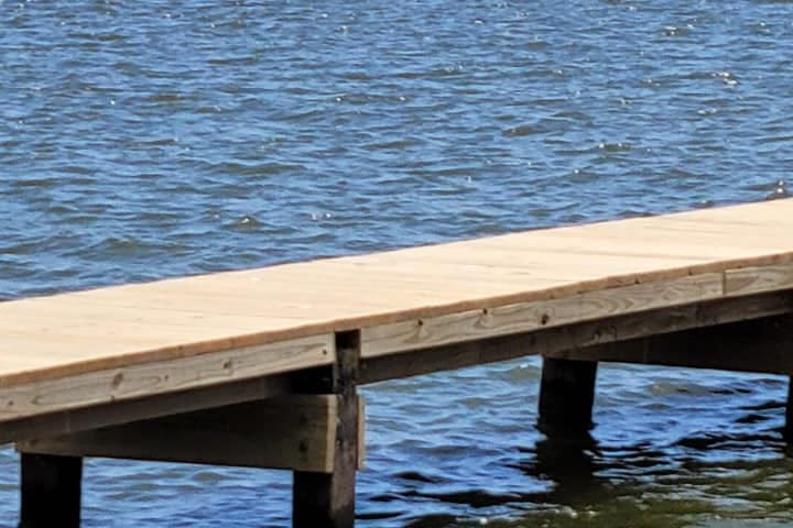 End of a rebuilt pier standing over open water