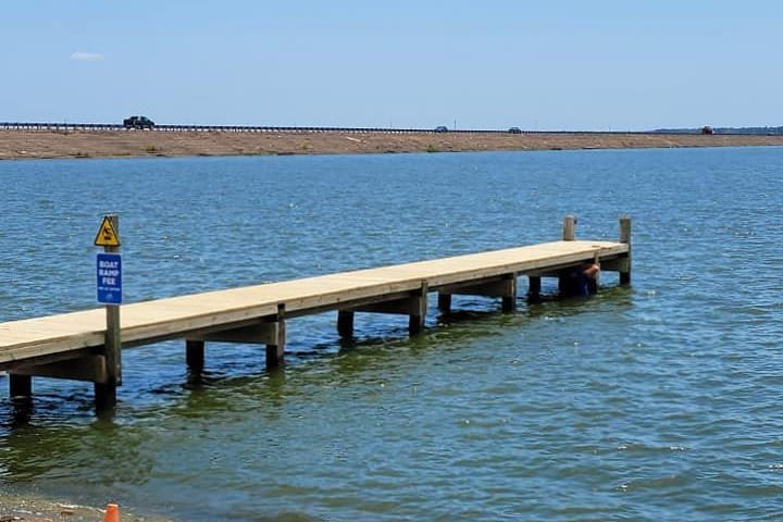 Rebuilt pier running out into the lake from the shoreline