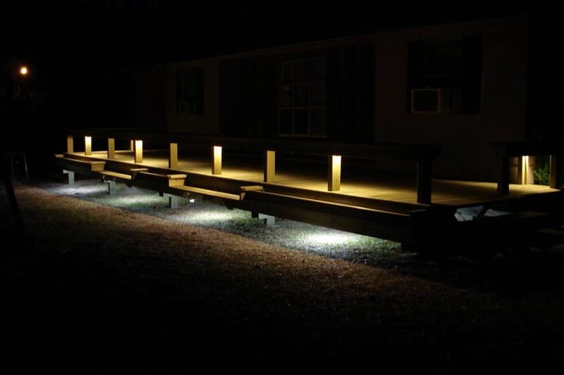 Pier with low lights along the walkway at night