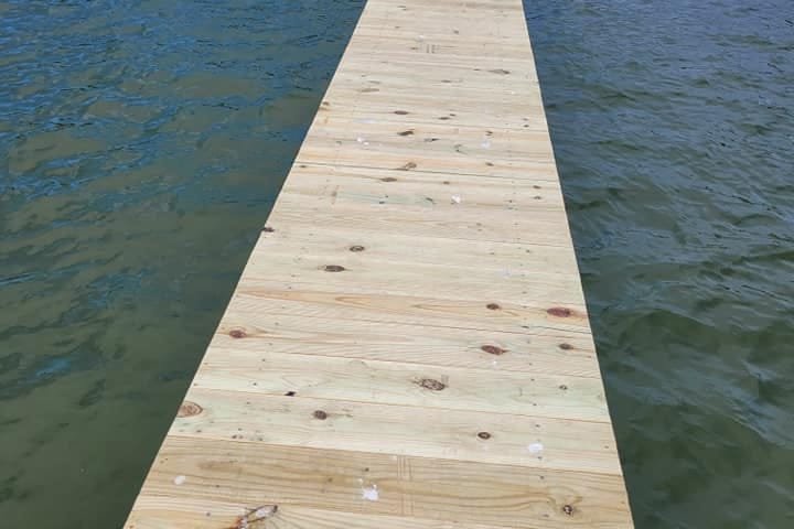Long boat pier with new wood decking over the lake