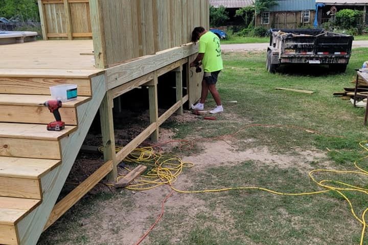 Crew building the stairs and privacy wall of a pool deck