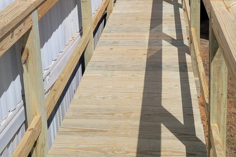 Pressure-treated ramp with handrails on both sides
