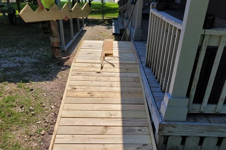 Wooden ramp leading up to a covered front porch