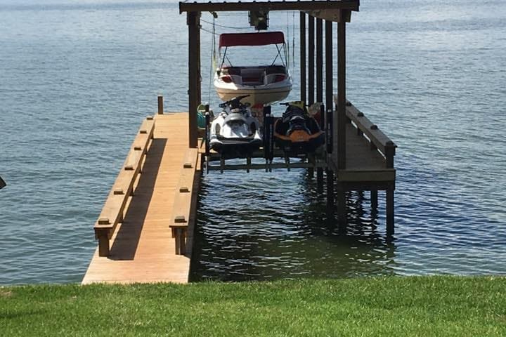 Personal watercraft raised on a lift at the end of a pier